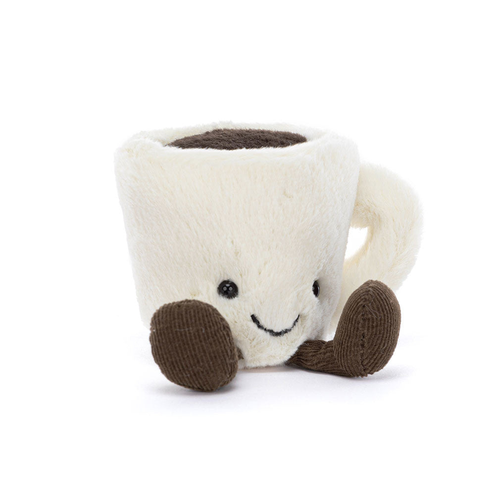 A plush coffee mug character toy with a cream-colored body, dark brown corduroy feet, and a simple embroidered smiley face, set against a plain white background.