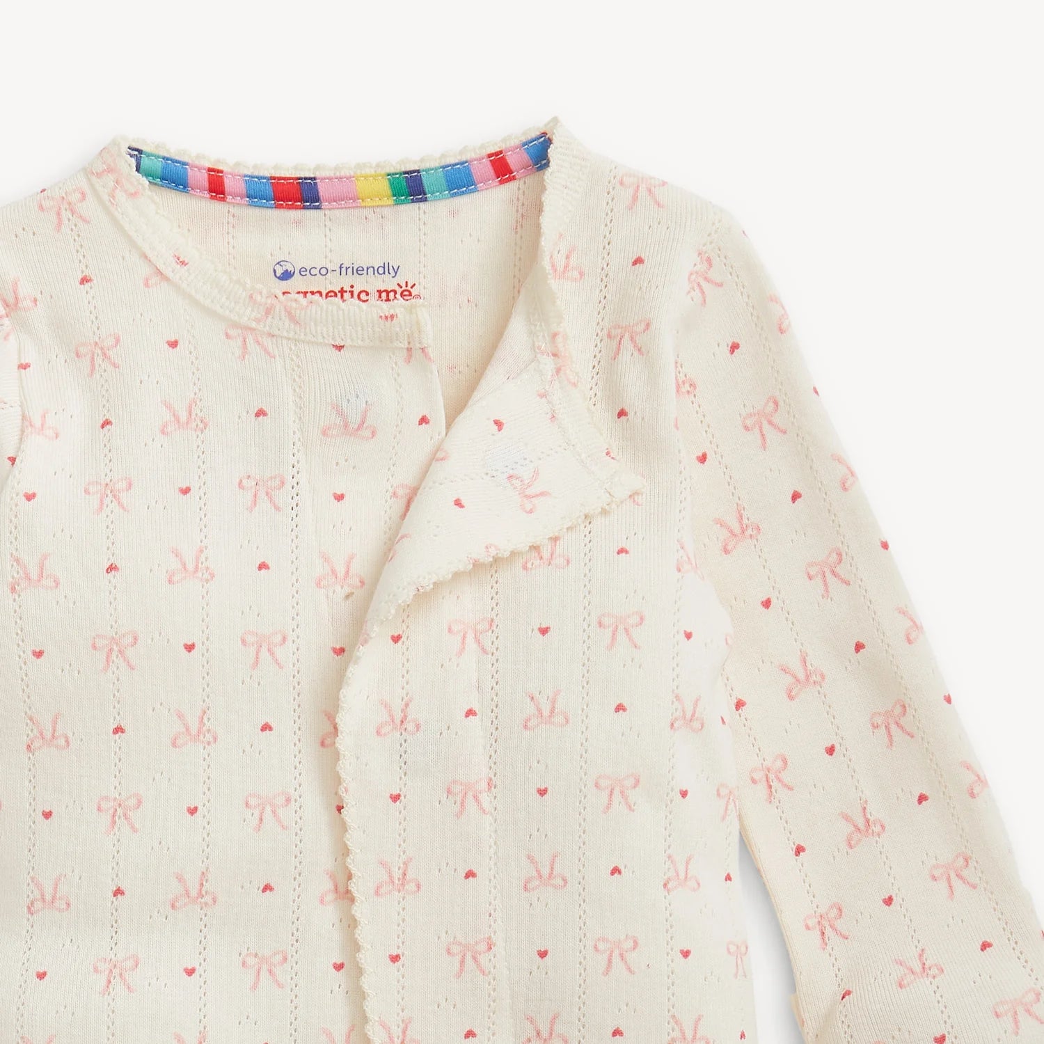 Baby onesie with bow and heart pattern on a white background