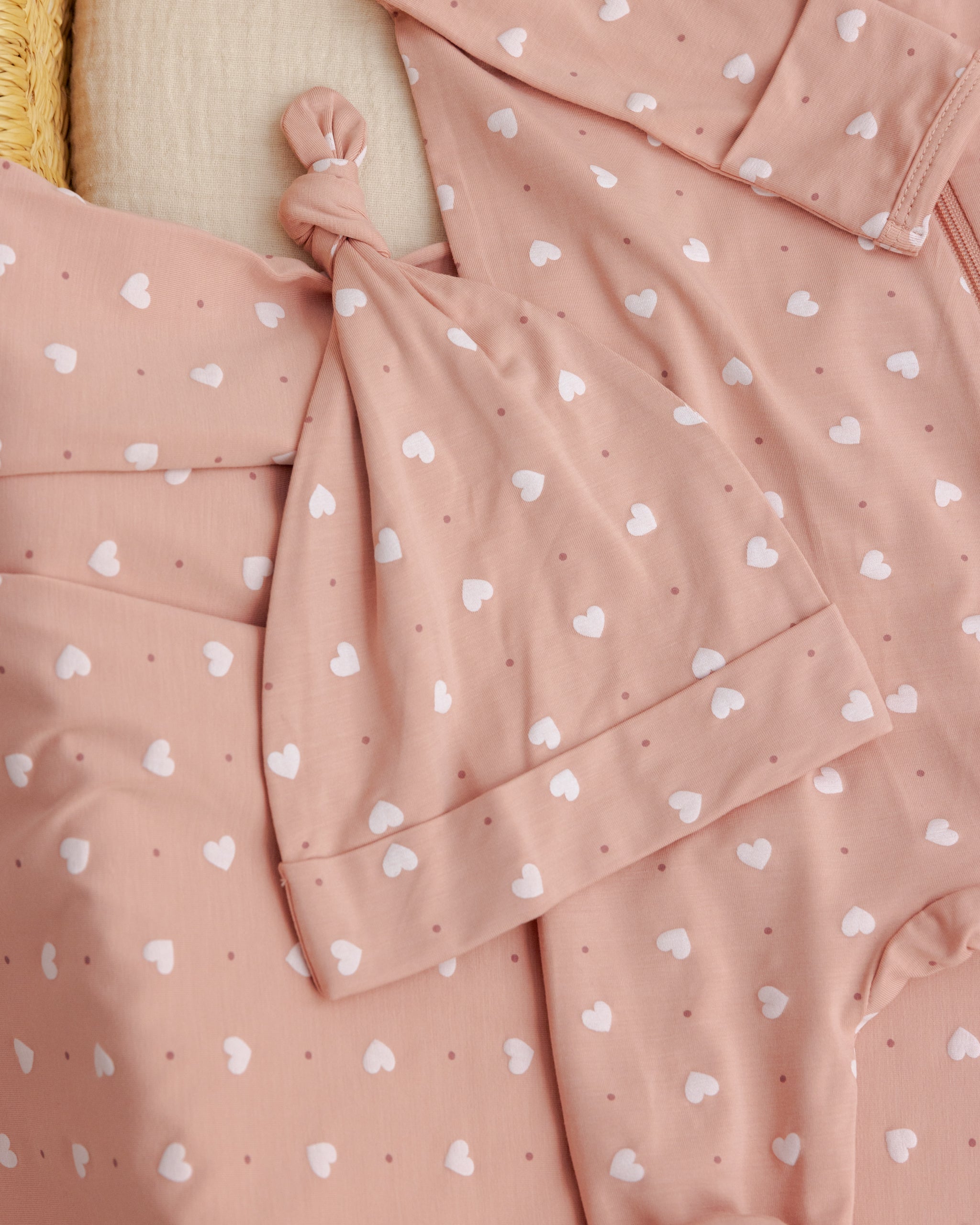 Pink polka dot dress with a knot detail on a beige background