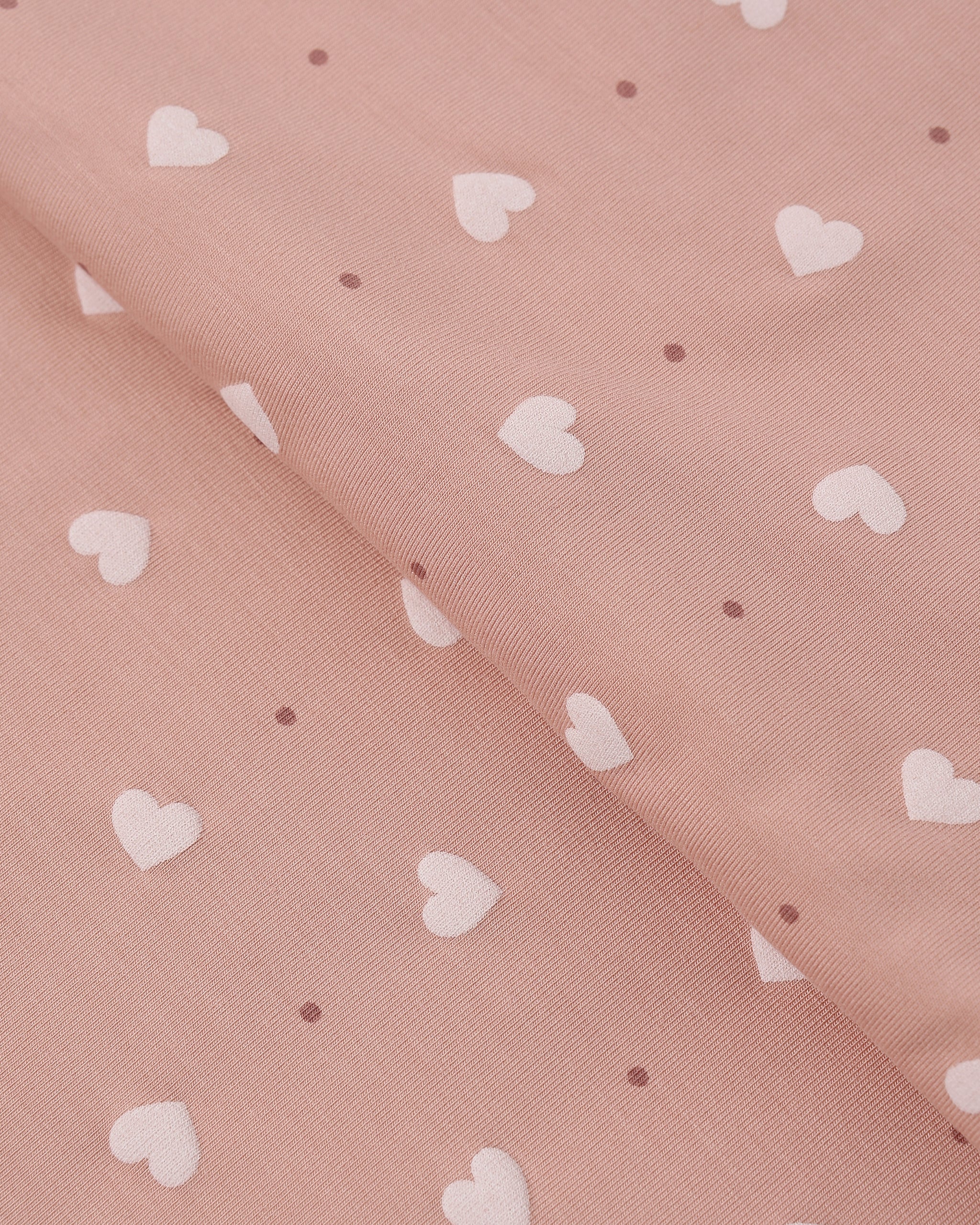 Pink fabric with white heart pattern