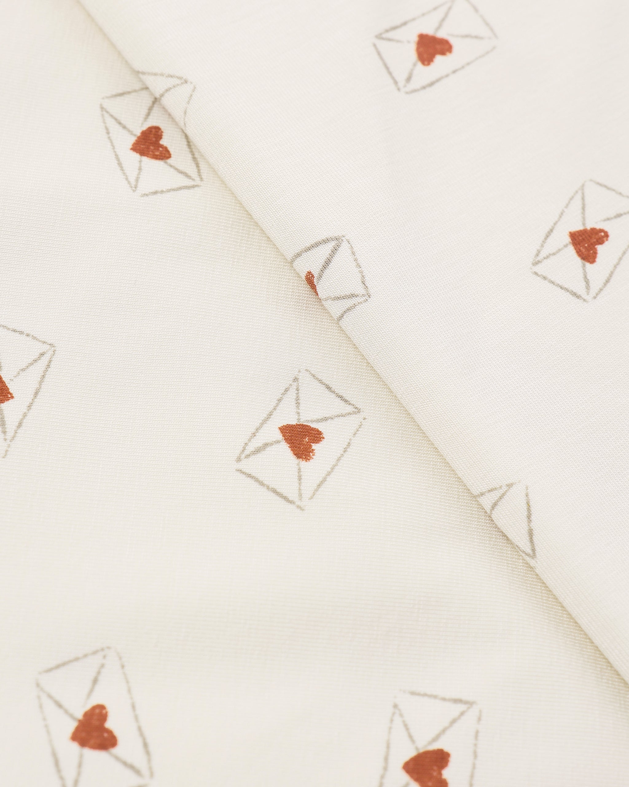 White fabric with red heart and white envelope pattern