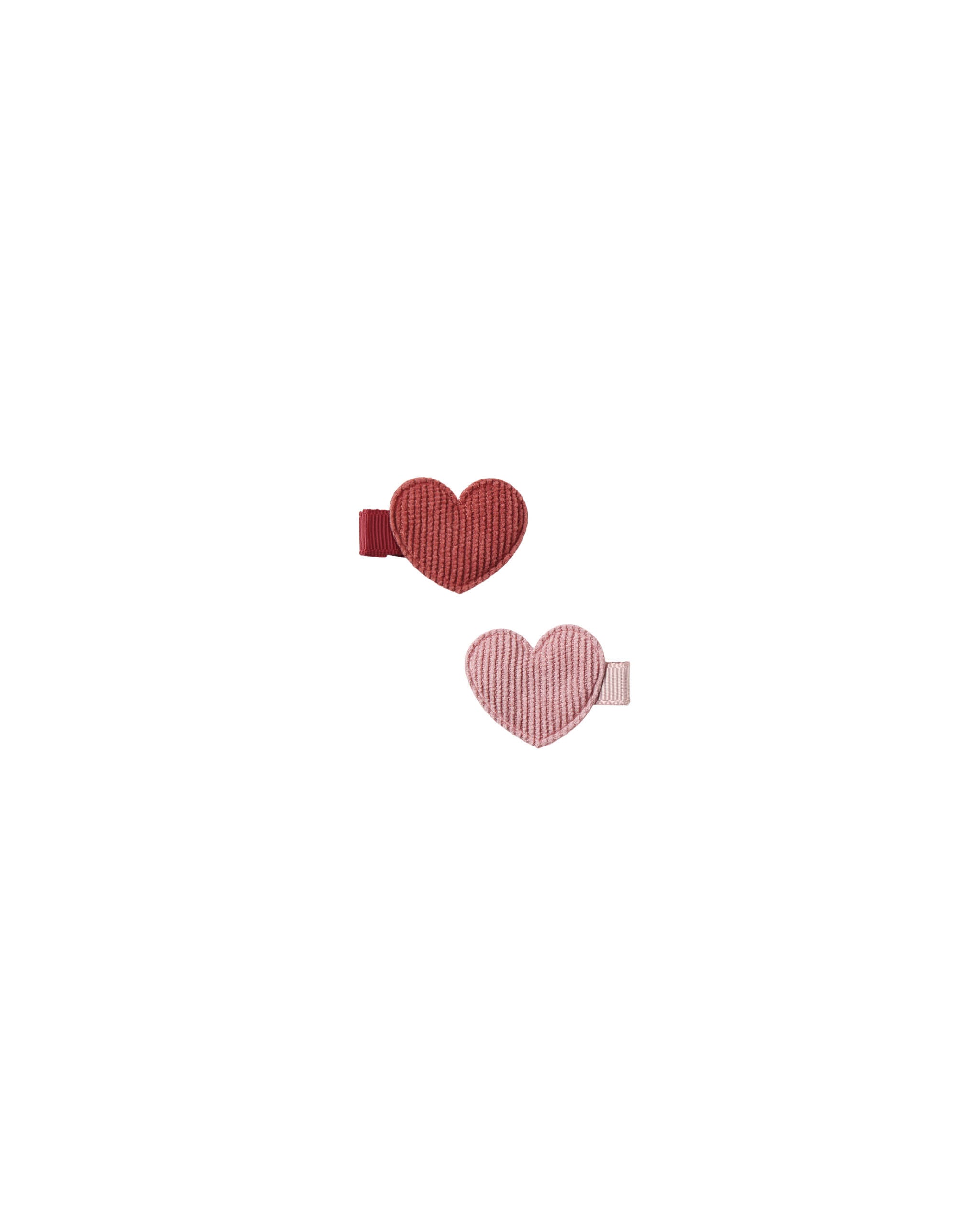 Two heart-shaped hair clips on a white background