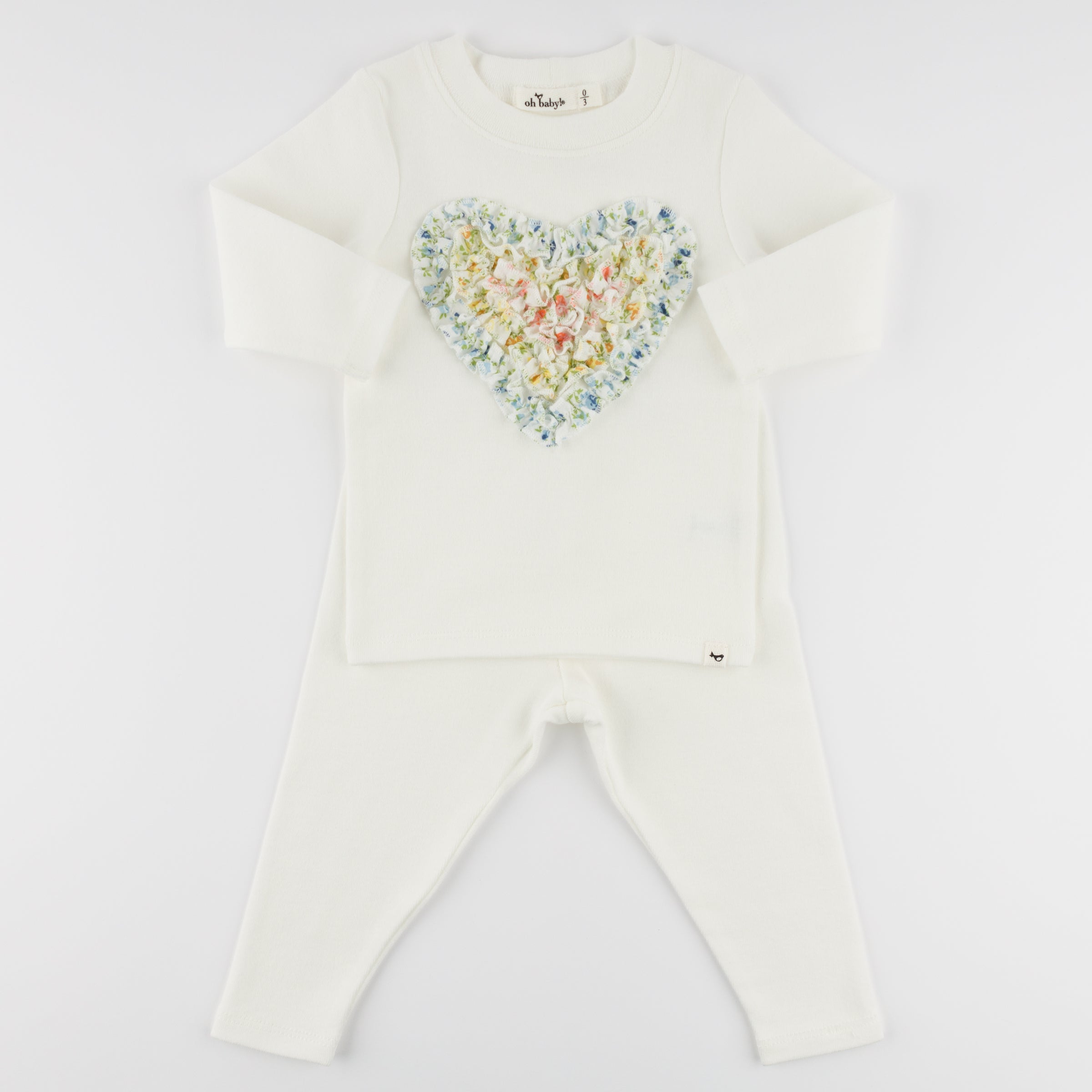 Cream baby set with a colorful heart design on a white background
