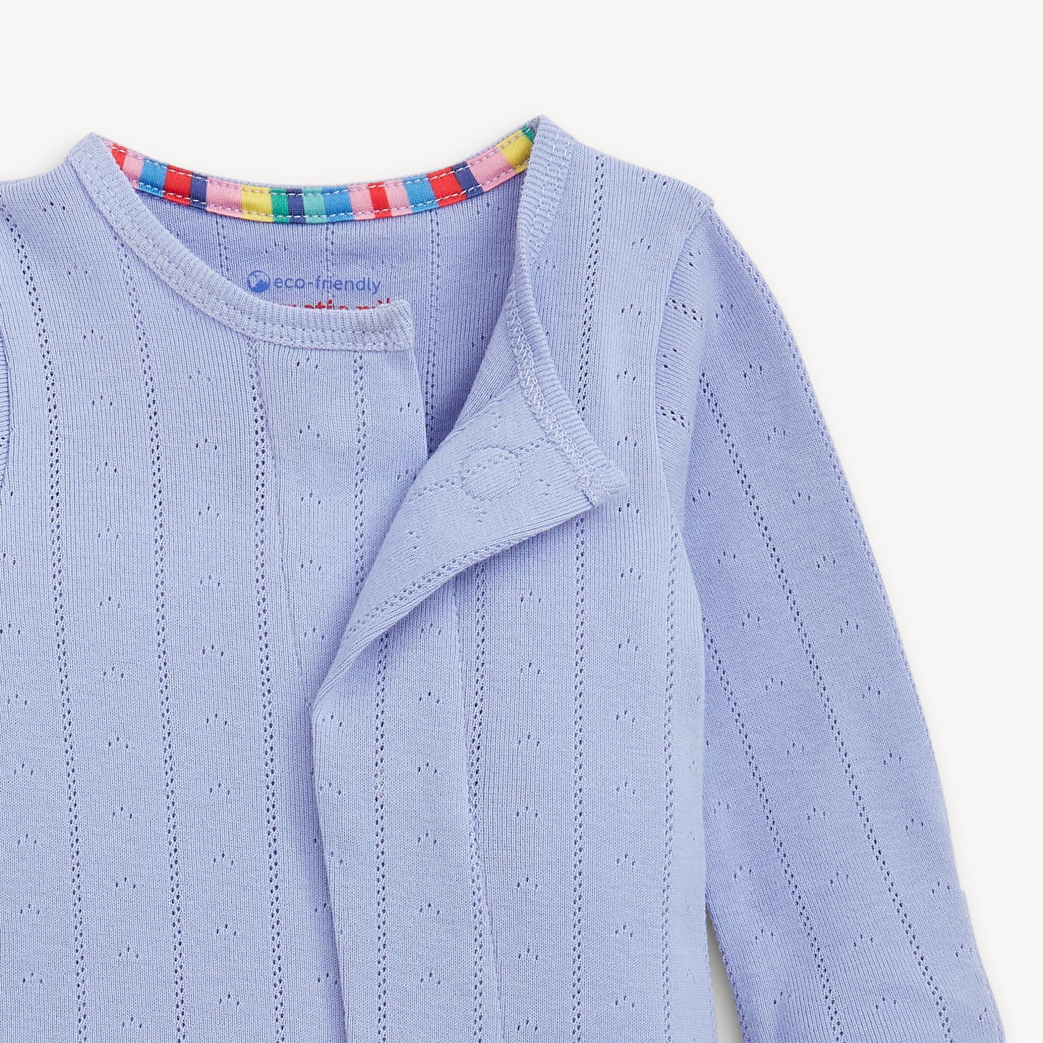 Light blue pointelle with a colorful striped collar on a white background