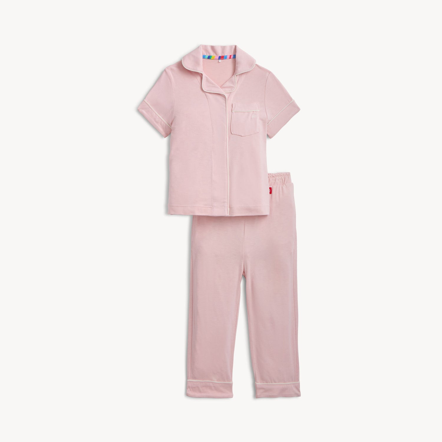 Pink pajama set with a colorful tag on a white background
