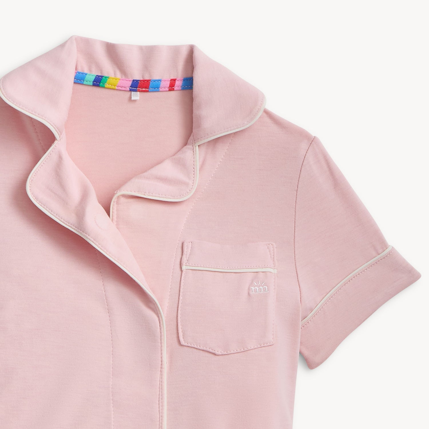 Pink pajama top close up picture with a colorful collar on a white background