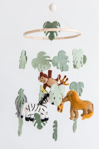 Baby mobile with jungle-themed animals and leaves on a white background