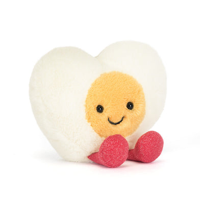 Heart-shaped plush toy with a smiling face on a white background