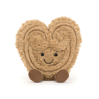 Heart-shaped plush toy with a smiling face on a white background