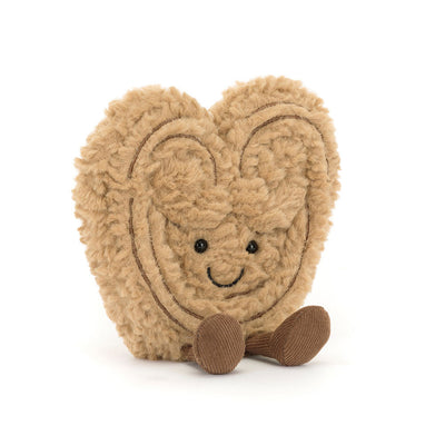 Heart-shaped plush toy with a smiling face on a white background