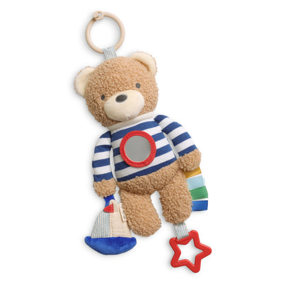 Teddy bear toy with striped shirt and colorful accents on a white background