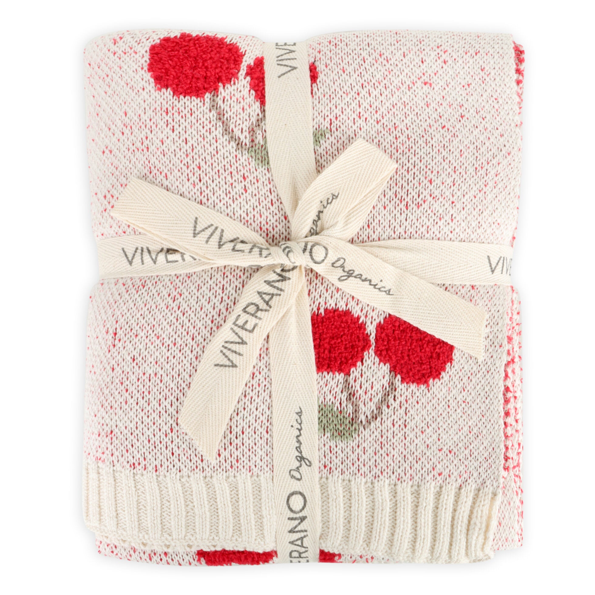 Knitted blanket with red cherry patterns and a visible brand label on a white background