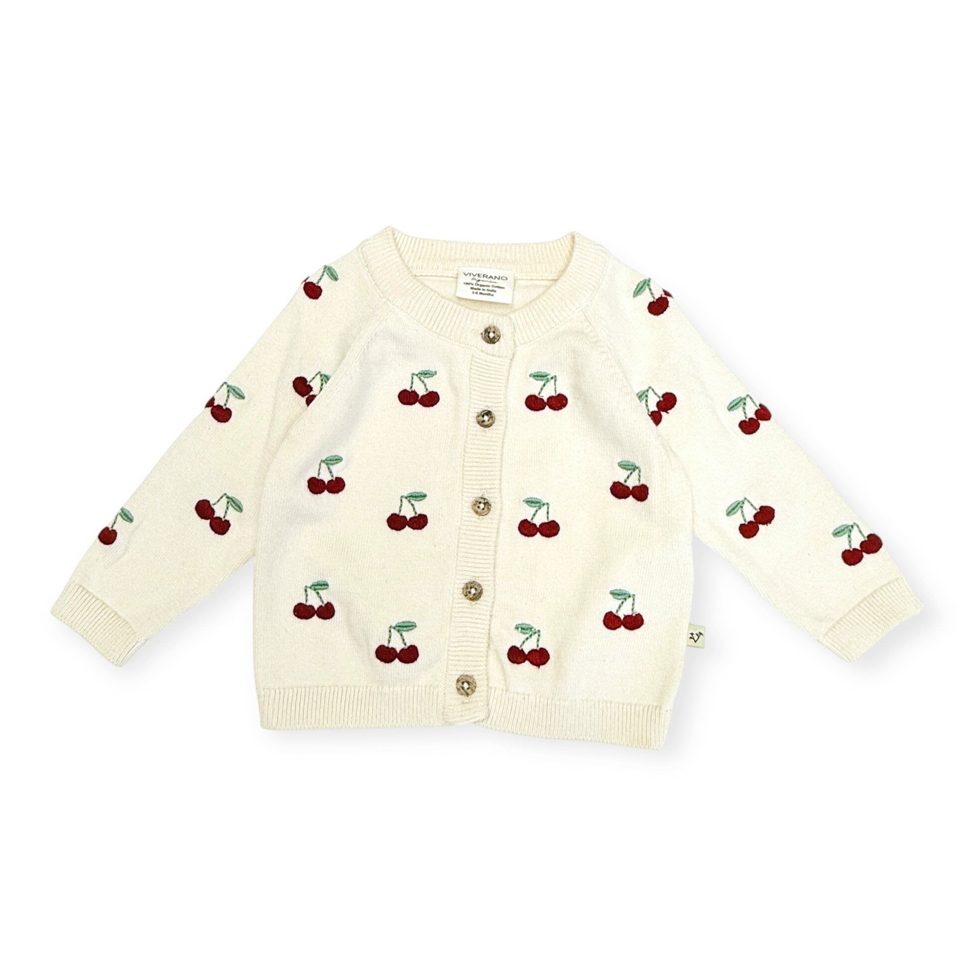 Cream-colored cardigan with cherry pattern on a white background
