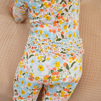 Floral patterned outfit on a child against a beige background