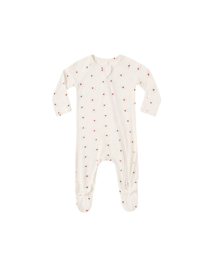 Baby onesie with red heart pattern on a white background