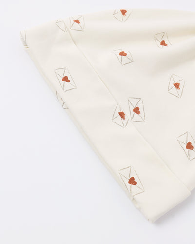 Folded fabric with heart and envelope patterns on a white background