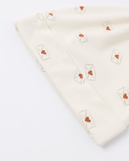Folded fabric with heart and envelope patterns on a white background