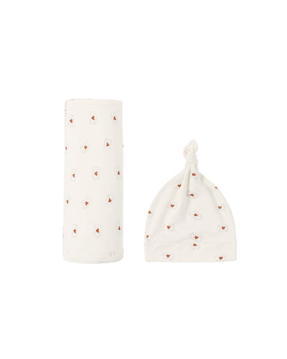 Baby hat and bottle cover with heart pattern on a white background