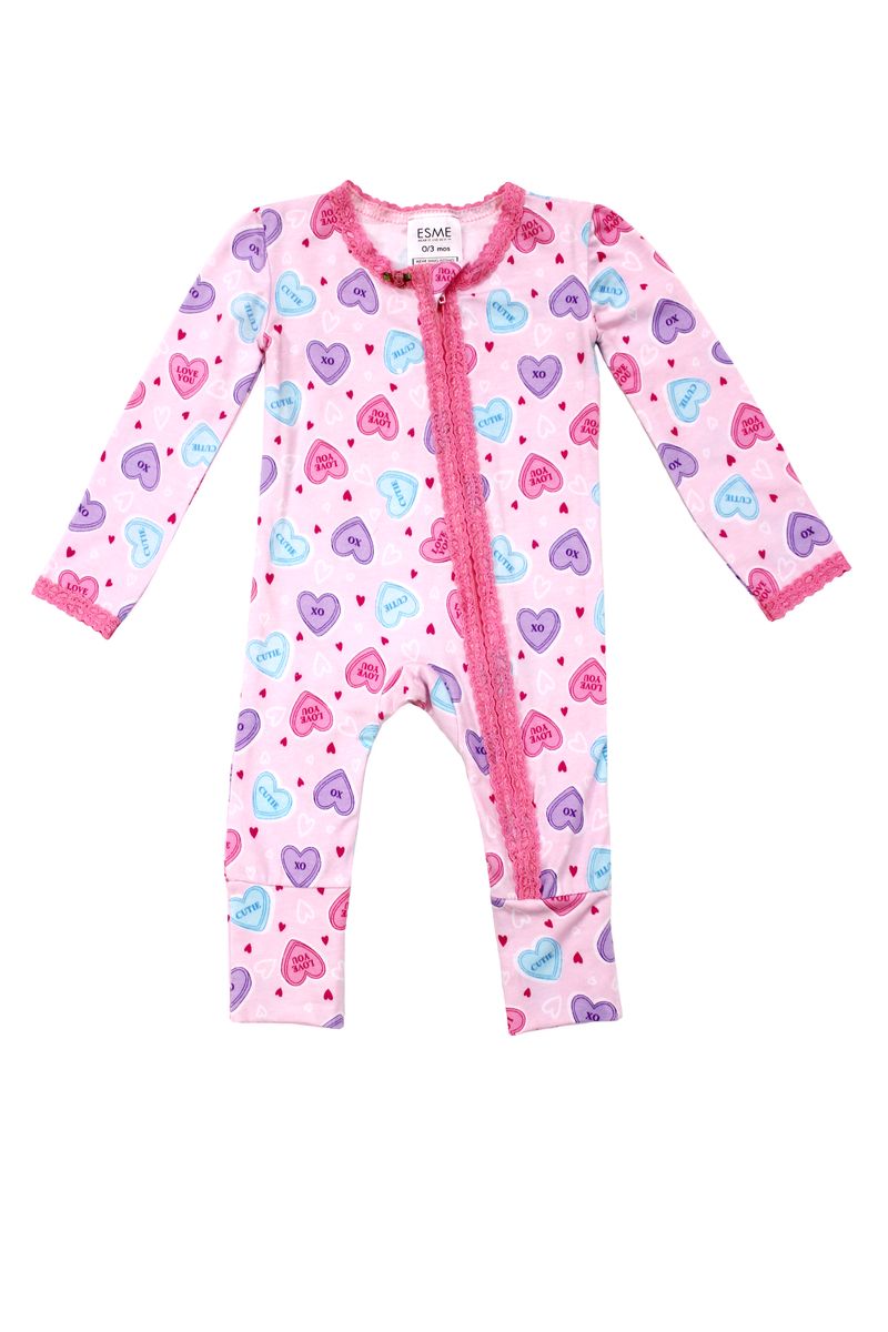Pink baby onesie with heart pattern on a white background