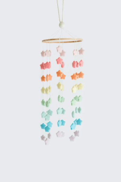 Colorful hanging mobile with stars and flowers on a white background