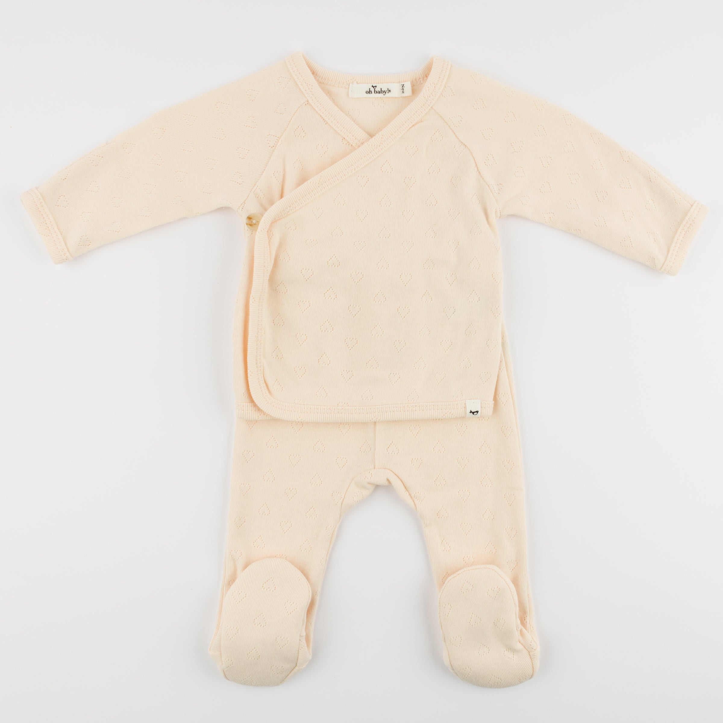 Beige baby onesie with a front pocket on a white background