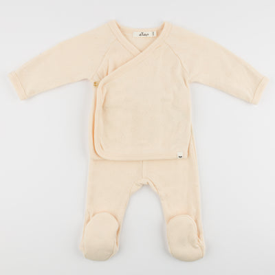 Beige baby onesie with a front pocket on a white background