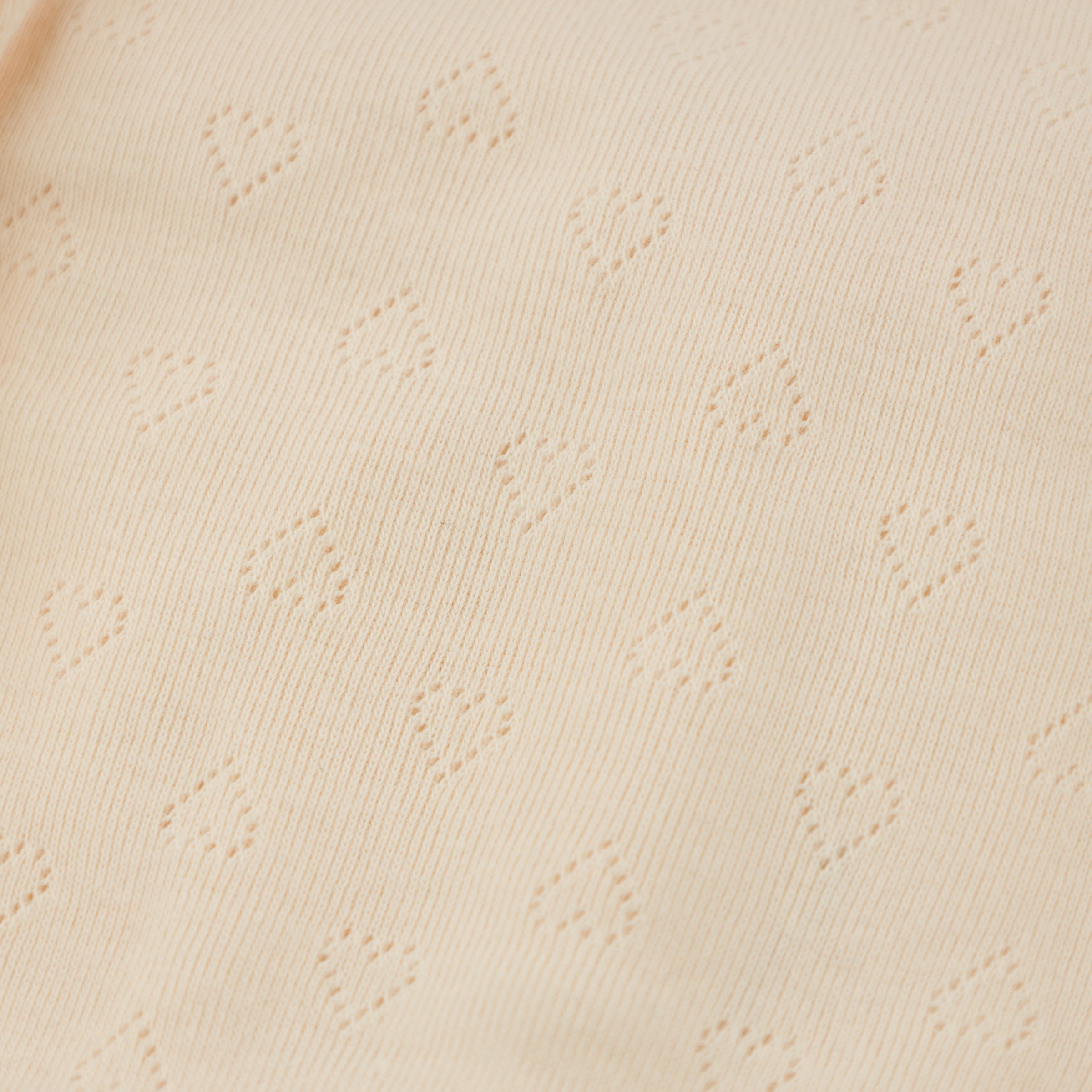 Close-up of beige fabric with subtle pattern