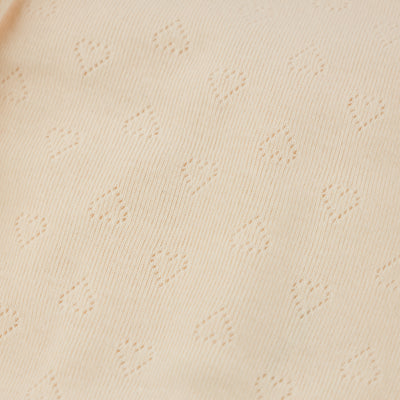 Close-up of beige fabric with subtle pattern