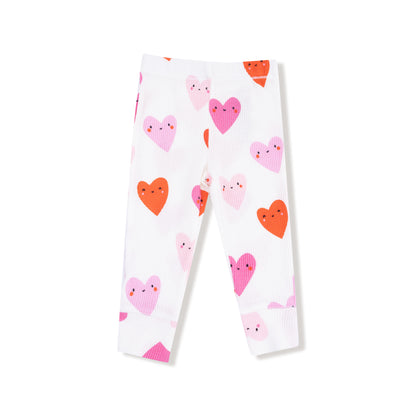 White leggings with pink and orange heart patterns on a white background