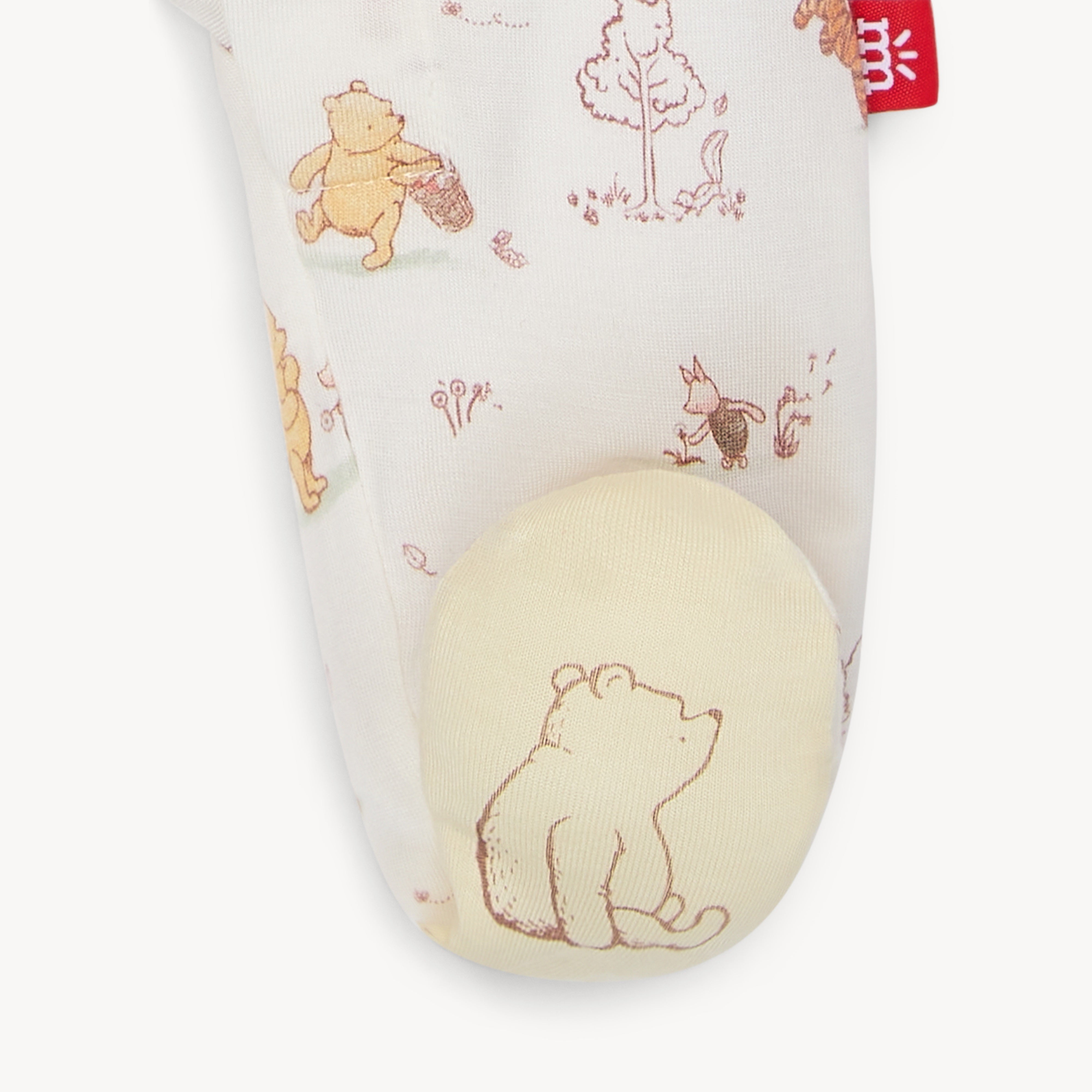 Close up picture of the footie with Winnie the Pooh design on a white background