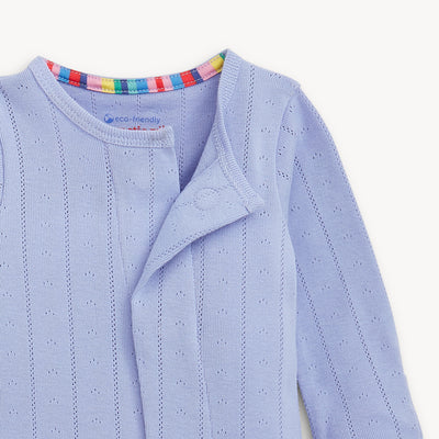 Light blue pointelle with a colorful striped collar on a white background