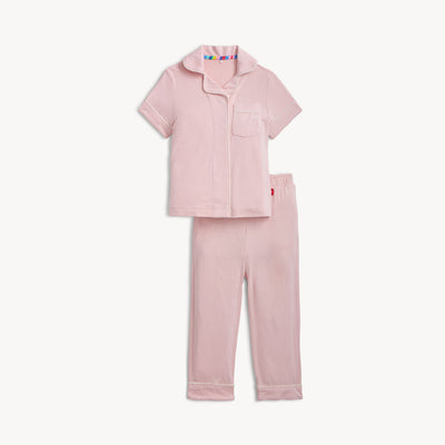 Pink pajama set with a colorful tag on a white background