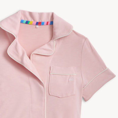Pink pajama top close up picture with a colorful collar on a white background